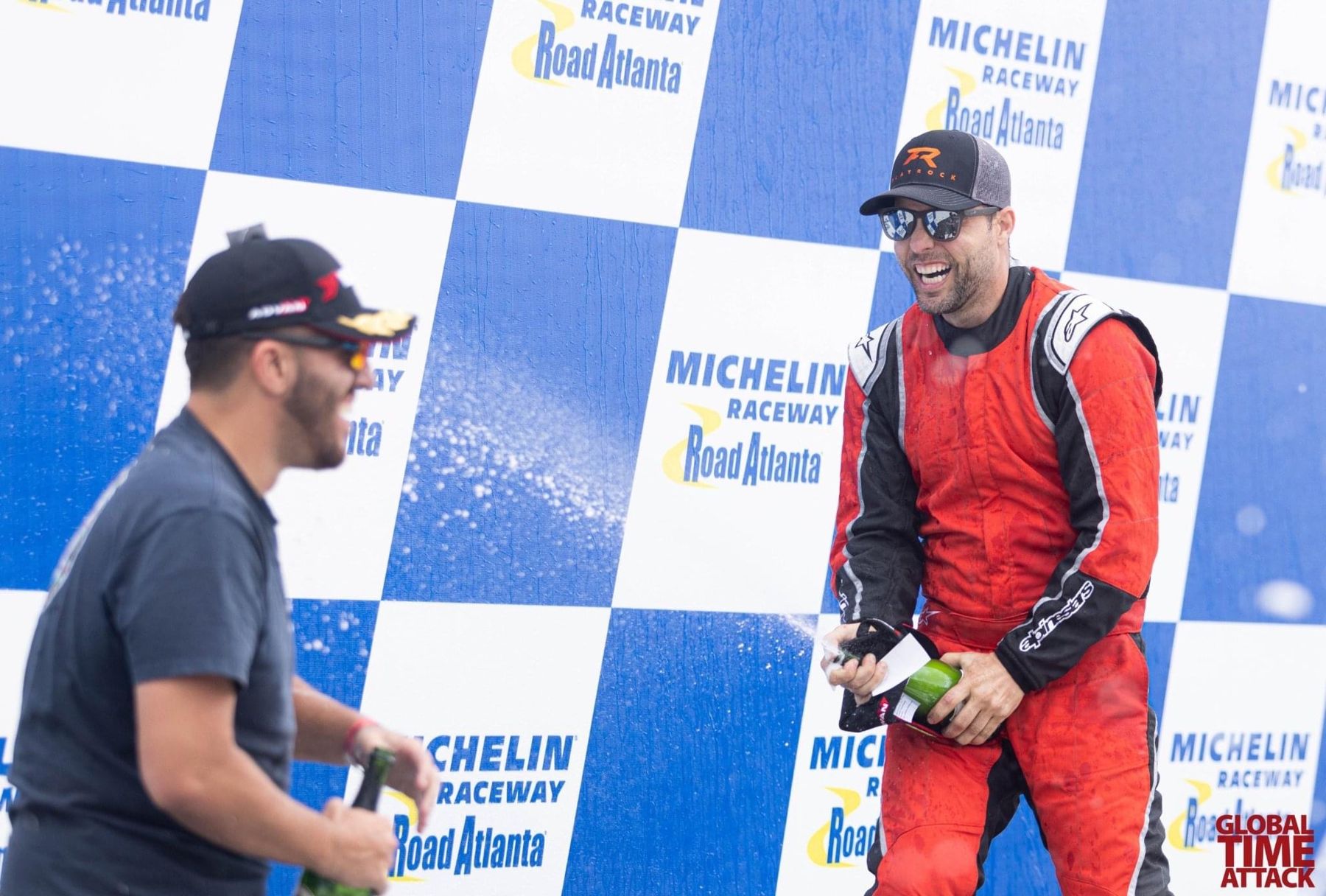 Jason spraying champagne on the Michelin Raceway Road Atlanta podium