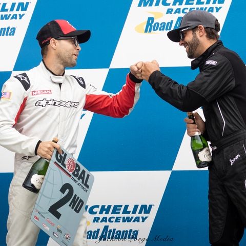 Jason fist-bumping a fellow driver on the Road Atlanta podium