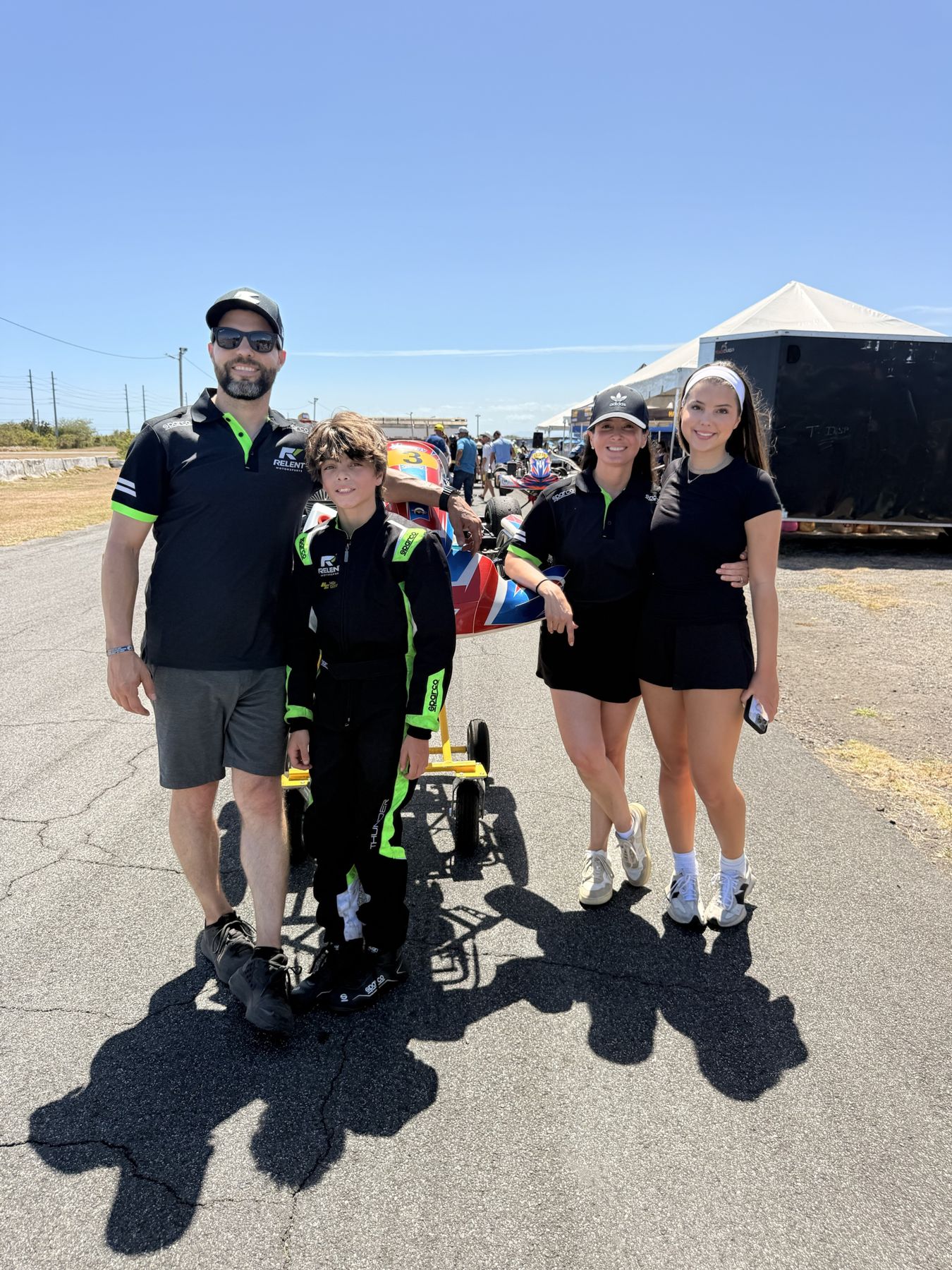 Jason with his family and his son's kart in the paddock