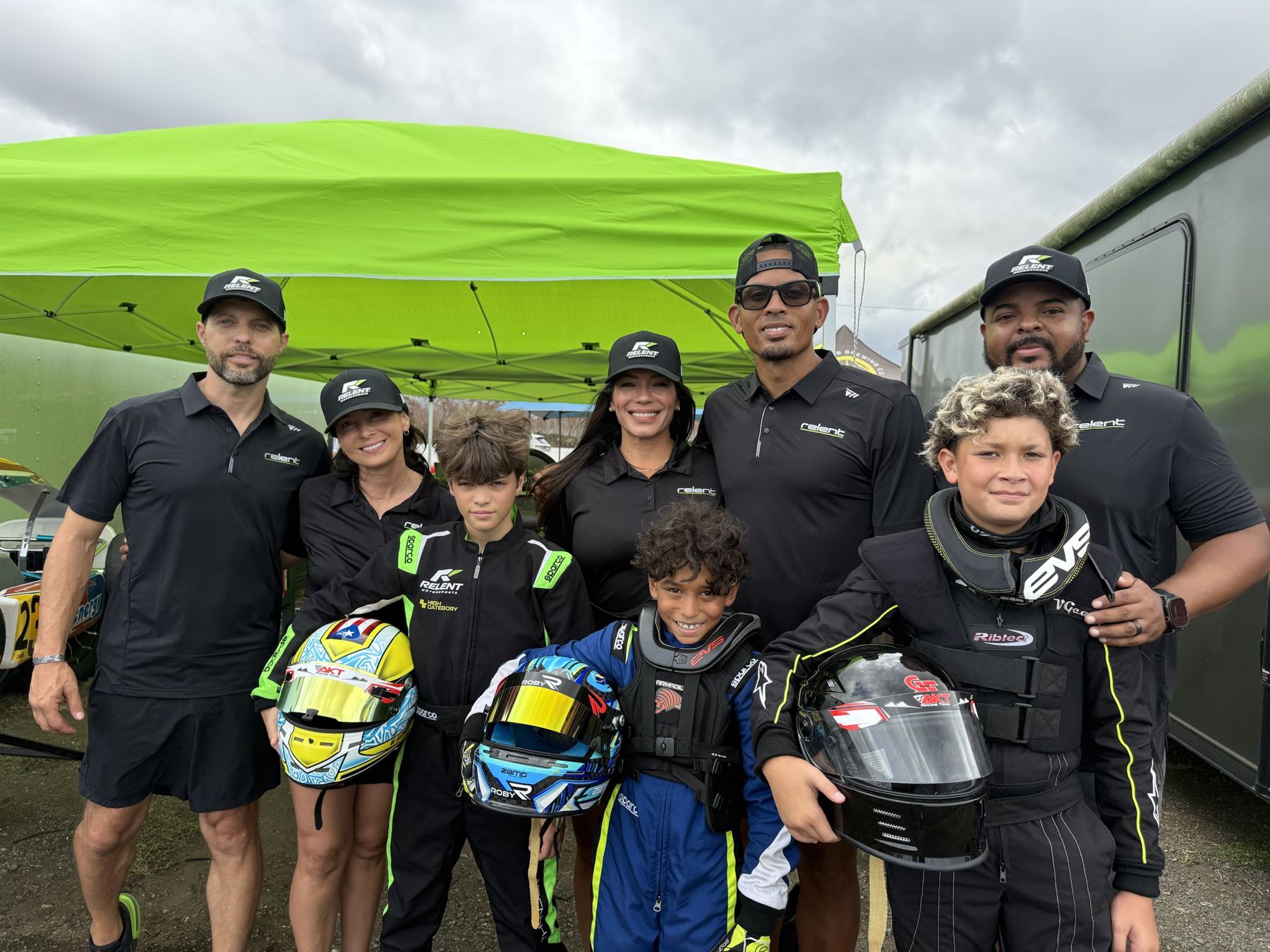 Relent Motorsports team, families and young drivers under the green team tent