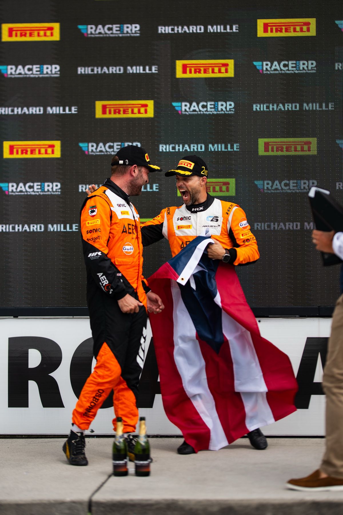 Jason celebrating with the Puerto Rican flag on the podium