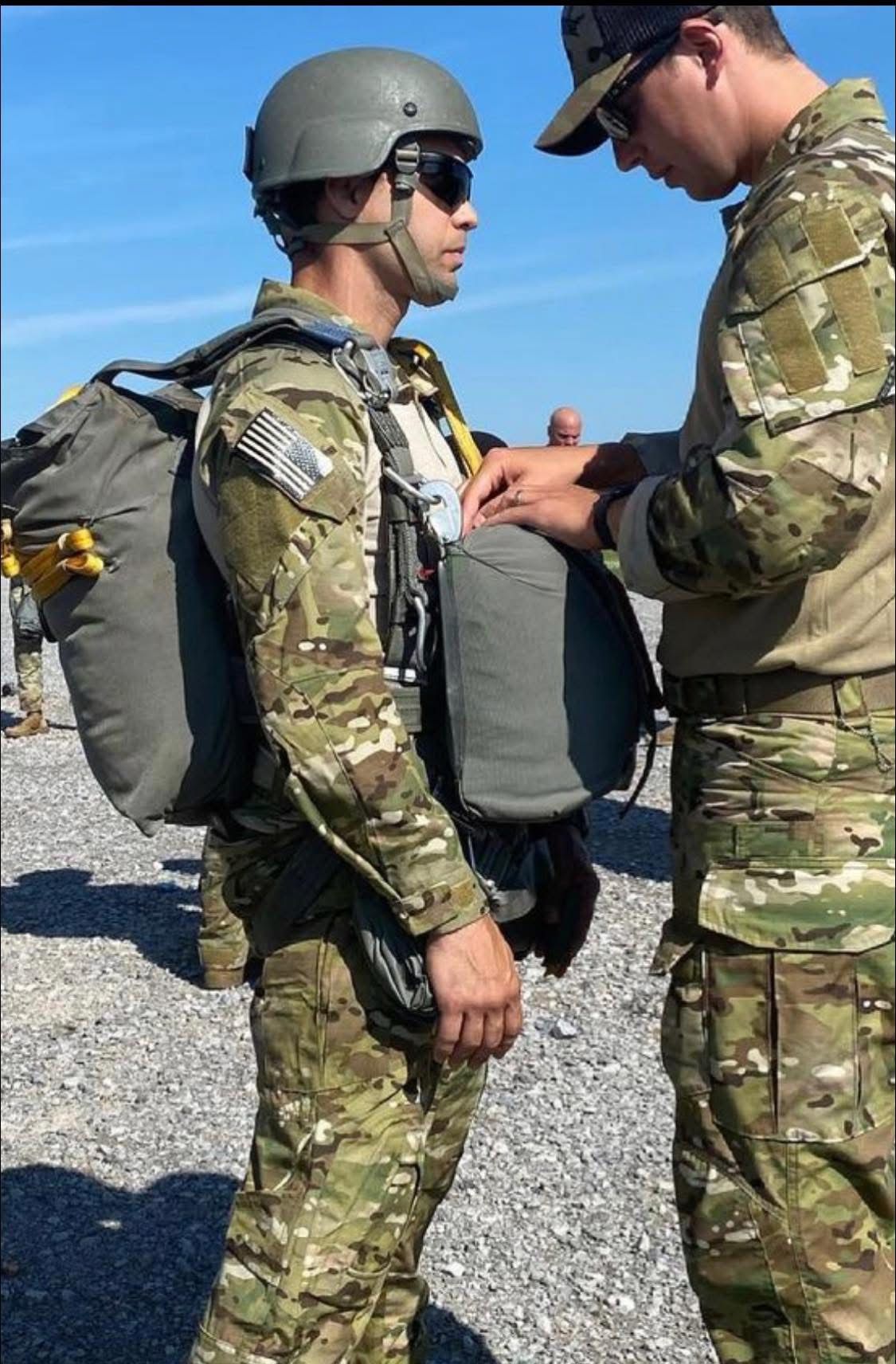 Jason in parachute gear getting a jumpmaster inspection